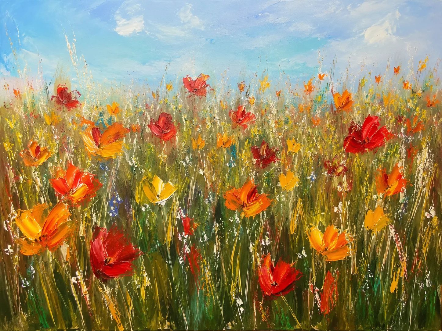 Flower meadow under a blue sky